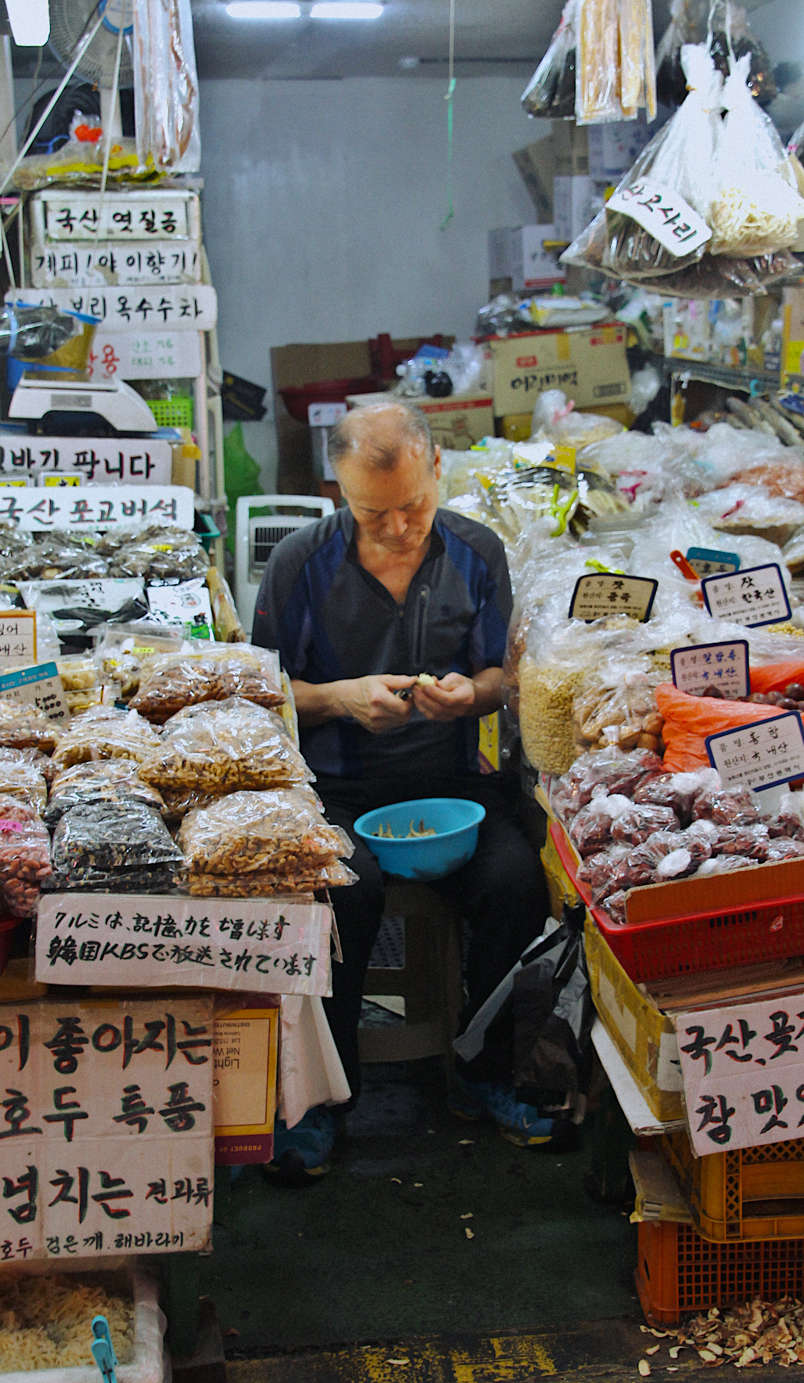 Man shaving nuts at a stall